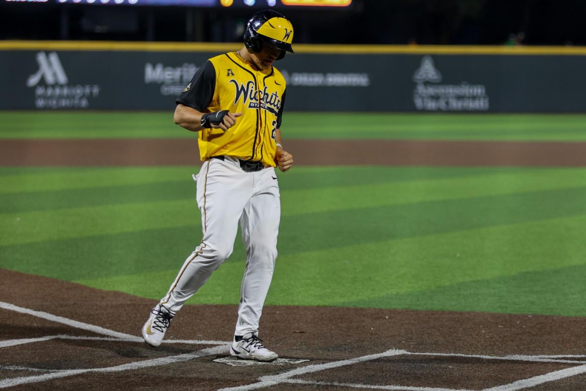 Wichita State baseball senior Owen Washburn (25) steps on home plate against Tulane on April 2 at Eck Stadium. Washburn scored one of the Shockers' two runs in a 4-2 loss.