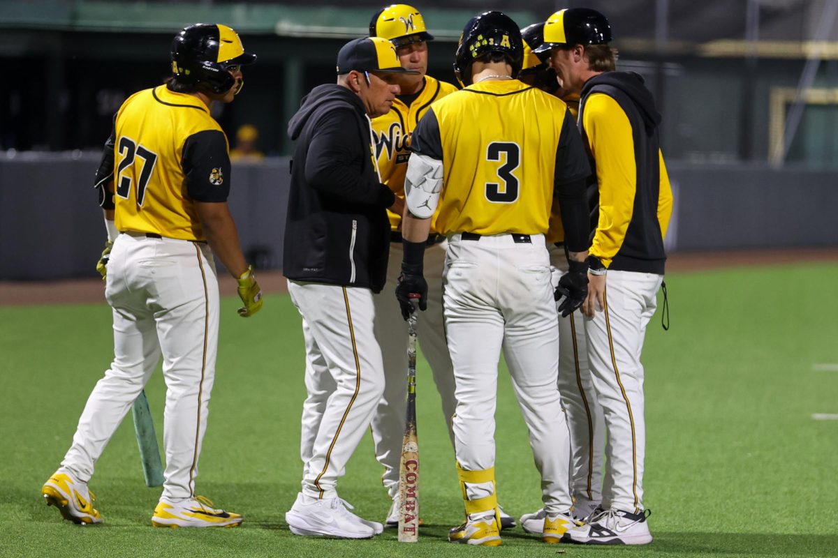 Wichita State head baseball coach Brian Green leads a hitter's meeting against Tulane on April 2 at Eck Stadium. The Shockers hit 9-for-36 during the game. (File photo)