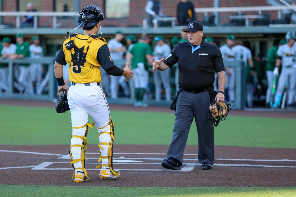 Wichita State baseball junior Ethan Gonzalez (3) shakes hands with home plate umpire Greg Harmon before the game against Tulane on April 2 at Eck Stadium. Gonzalez was the Shockers' starting catcher.