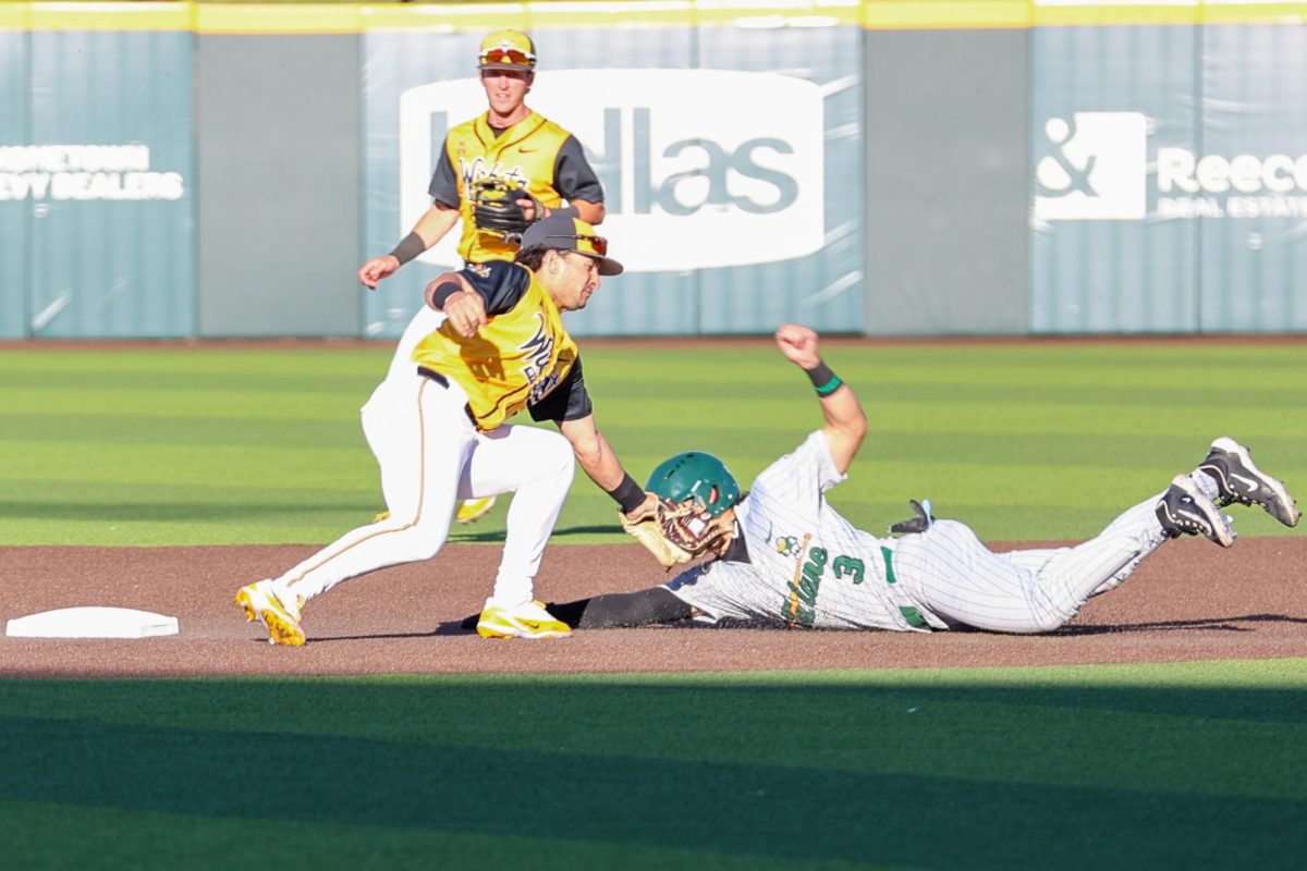 Wichita State baseball junior Owen Rush (43) tags a Tulane runner out while attempting to steal second on April 2 at Eck Stadium. The Green Wave didn't steal a base during the game.