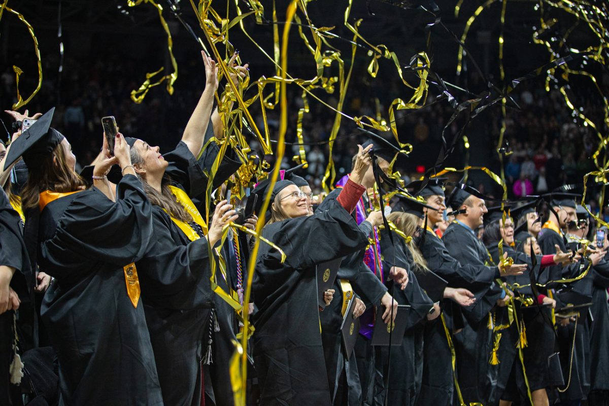 Graduates celebrate with music and streamers on Dec. 14. The Shocker Sound Machine performed at the event. (File photo)