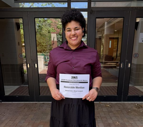 Arts and Culture Editor Maleah Evans poses with their award from the 2026 Kansas Collegiate Media Conference. (Photo courtesy of Maleah Evans.)