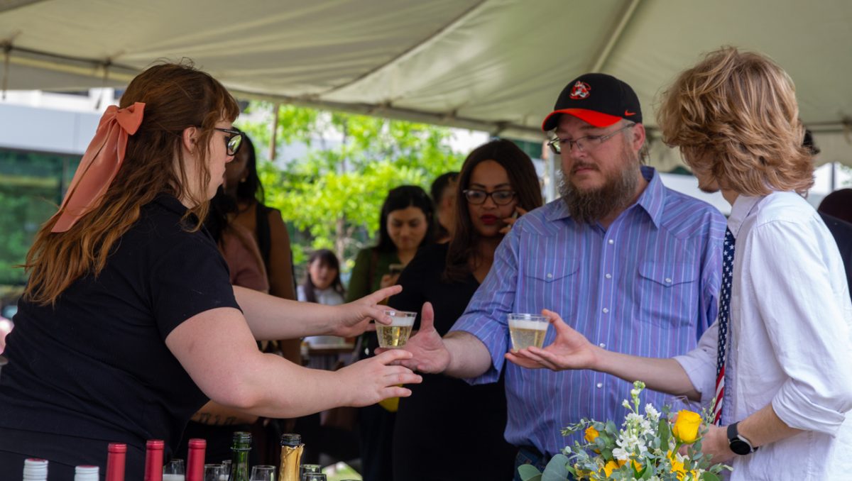 A worker hands attendees alcoholic beverages at The Toast. Graduates were allowed to bring family and friends to help them celebrate.