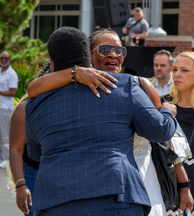 Graduate Cynthia Pizzini hugs another graduate at The Toast. Before the official ceremony, attendees were able to buy beverages and talk with each other.