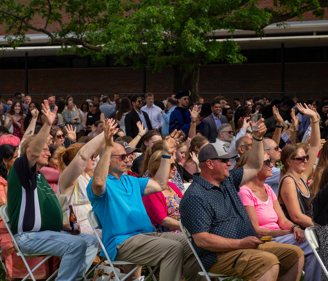 Guests of graduates raise their hands during the ceremony at The Toast during WSU Foundation & Alumni Engagement CEO Telly McGaha's speech. The Toast has been around since 2018.