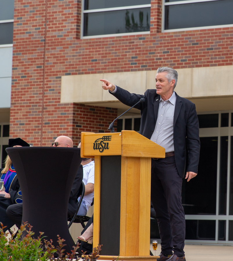 Wichita State President Richard Muma points to the crowd to chant "always a Shocker" back to him after he said "once a Shocker." Muma is the 15th president at WSU.