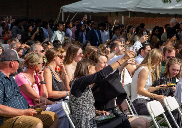 A graduate and her guest raise their champagne flutes in celebration. The Toast was created to honor graduates at a more casual event than commencement.