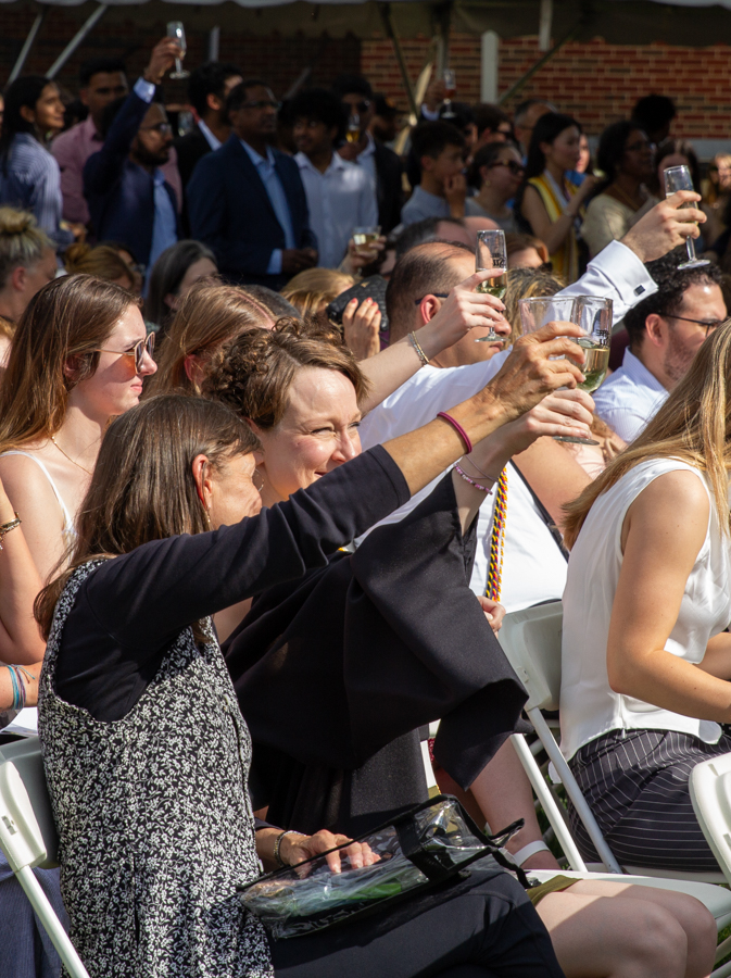 A graduate and her guest raise their champagne flutes in celebration. The Toast was created to honor graduates at a more casual event than comencement.