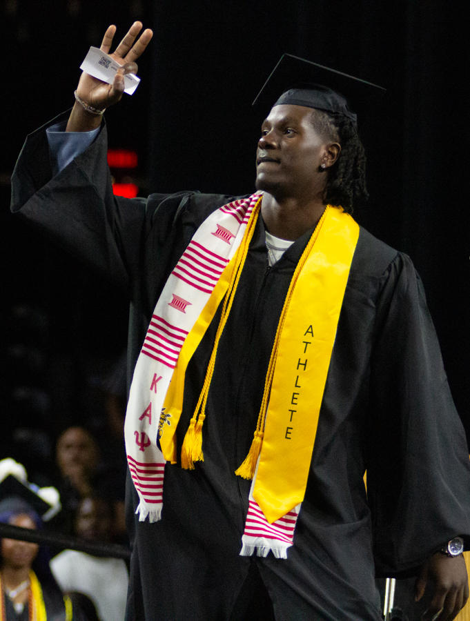 Graduate Karon Boyd, a former player of the Wichita State men's basketball team, throws up three fingers. Boyd commited to WSU last year.