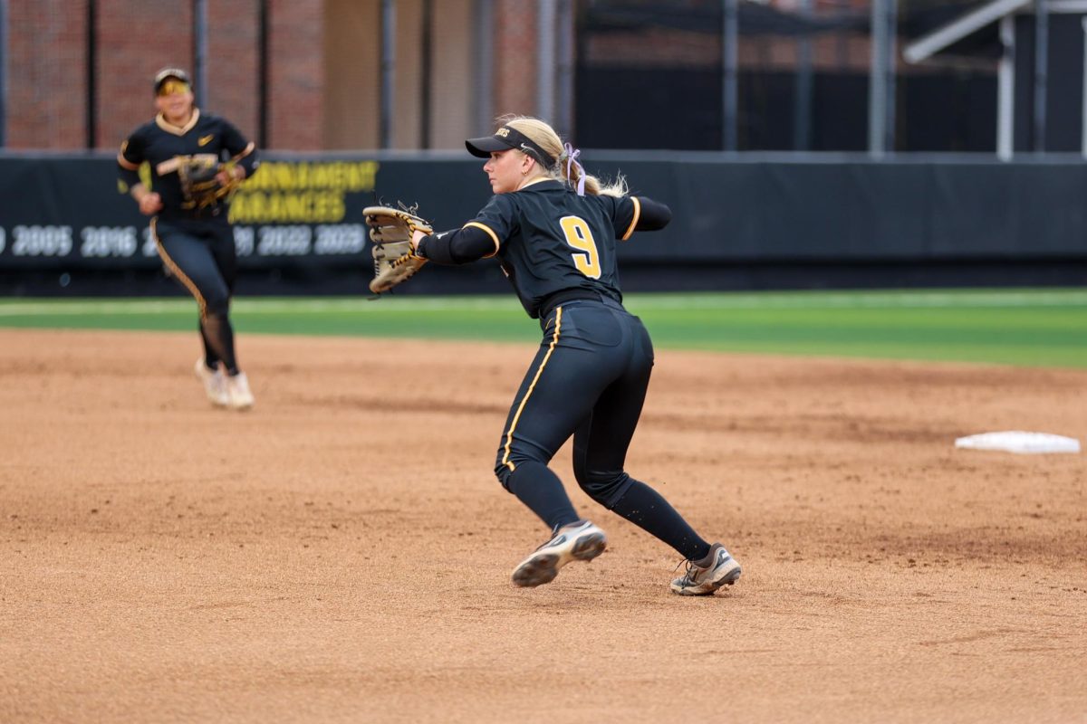 Wichita State softball freshman second baseman Kammie Smith (9) looks to throw a Memphis runner out at first base on May 1 at Wilkins Stadium. The Shockers won, 15-2.