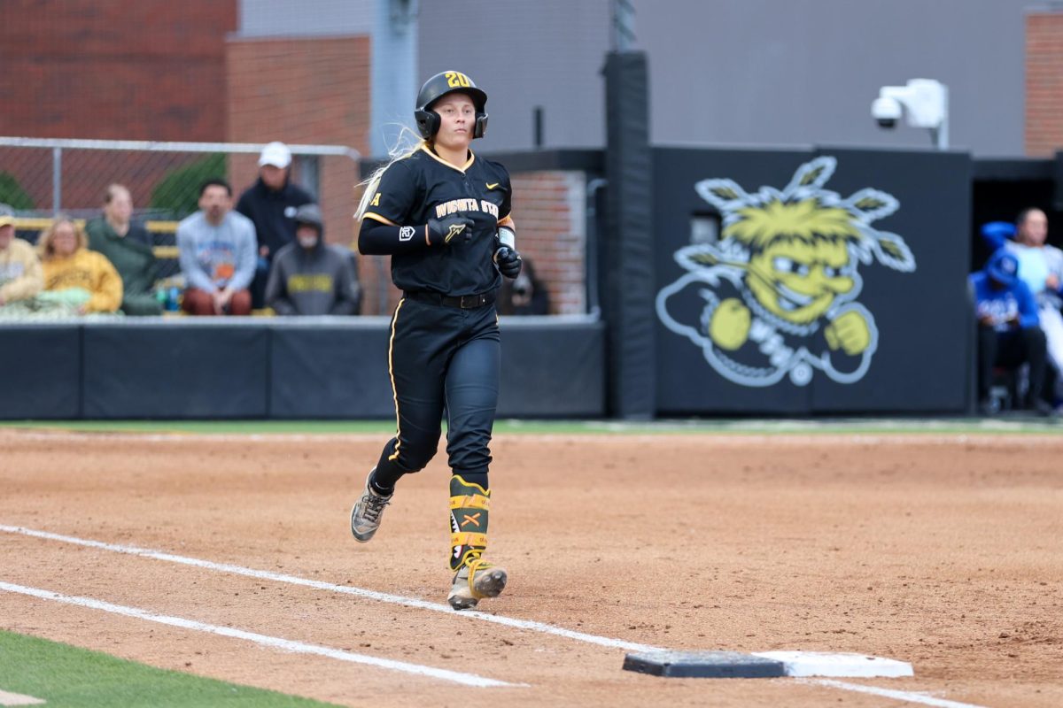 Wichita State softball freshman third baseman Kinzey Woody (20) trots to first base after coercing a walk against Memphis on May 1 at Wilkins Stadium. Woody reached first via base-on-balls three times against the Tigers.