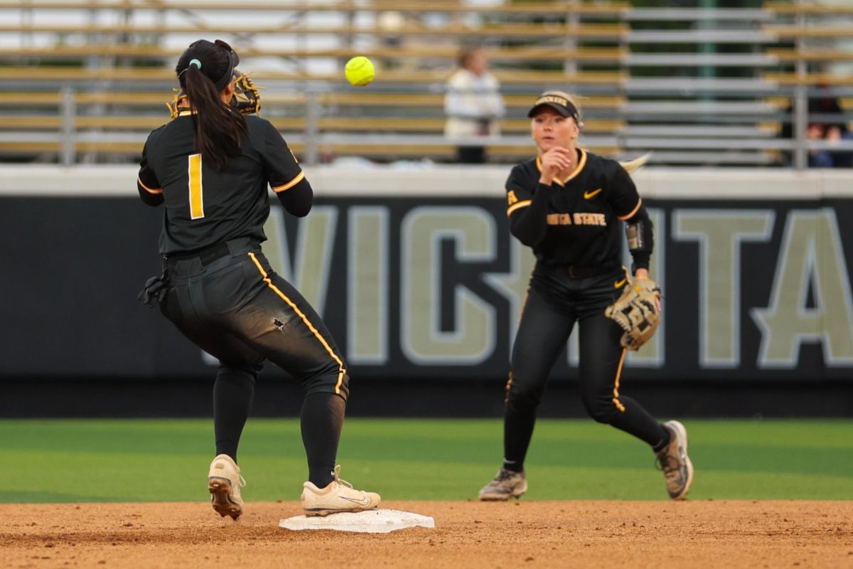 Wichita State softball freshman second baseman Kammie Smith (9) flips the ball to senior shortstop Chloe Rhine (1) for a force out against Memphis on May 1 at Wilkins Stadium. The play at second concluded the top of the fourth inning.