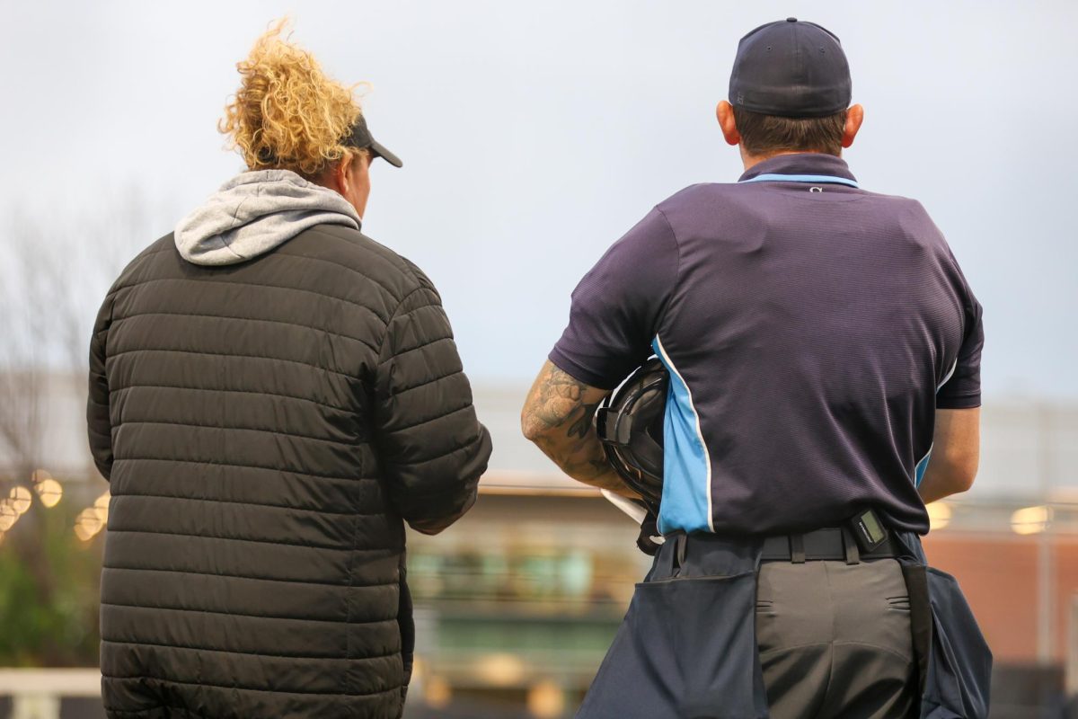 Wichita State head softball coach Kristi Bredbenner talks with home plate umpire Blake Solmi about a lineup change during a game against Memphis on May 1 at Wilkins Stadium. The Shockers won, 15-2.