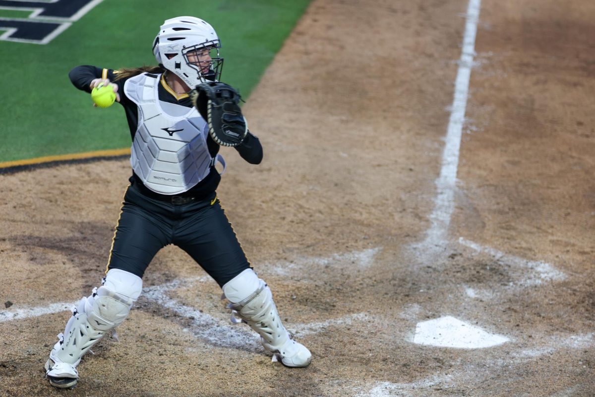 Wichita State softball sophomore catcher Aeryn Shuman (78) throws the ball to first base after sophomore pitcher Ava Sliger (5) struck out a Memphis Tiger on May 1 at Wilkins Stadium. Sliger recorded two strikeouts in the 15-2 win.