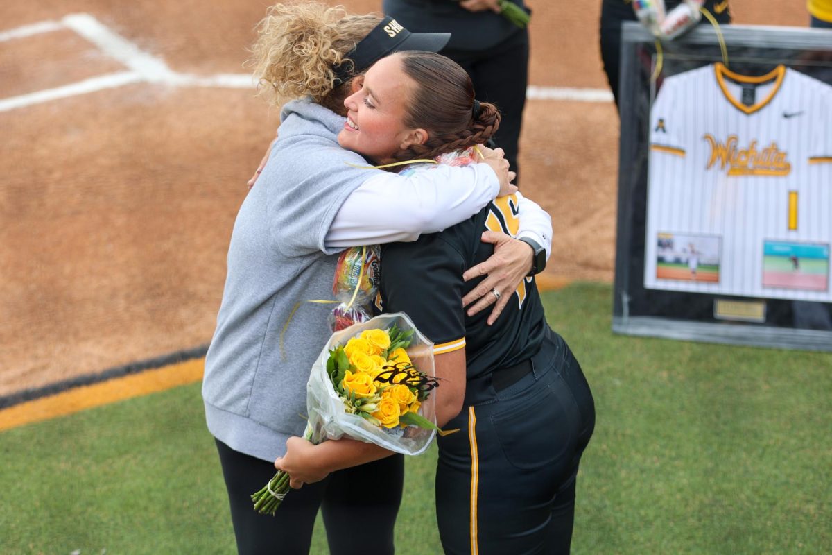Wichita State head softball coach Kristi Bredbenner and senior pitcher Jade Sanders (15) hug during the Senior Day ceremony before a game against Memphis on May 1 at Wilkins Stadium. Sanders was one of three seniors who were honored before the game.