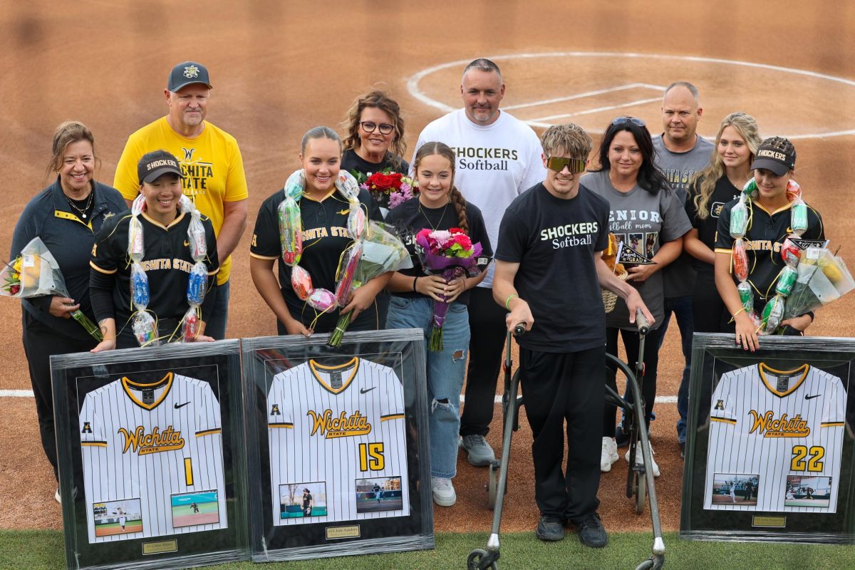 The Shockers softball seniors and their families take a photo after the senior celebration. The ceremony took place before the game.
