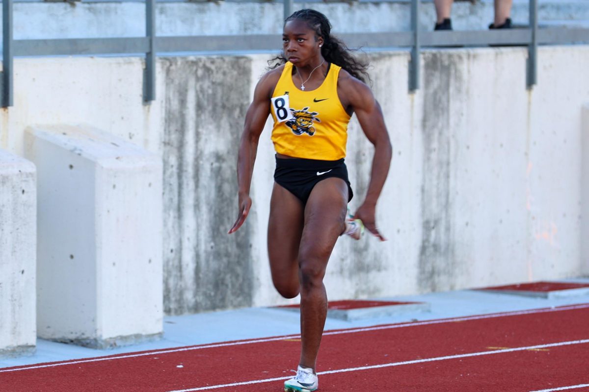 Wichita State track and field junior Miya Evans runs in the 100-meter dash at the Shocker Open on May 8 at University Stadium. Evans Finished in fourth.