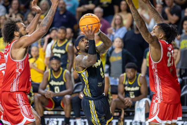 AfterShock Guard Marcus Keene attempts a layup between two Enchantment defenders on during Game 3 of TBT on July 23. The AfterShocks won, 73-67.