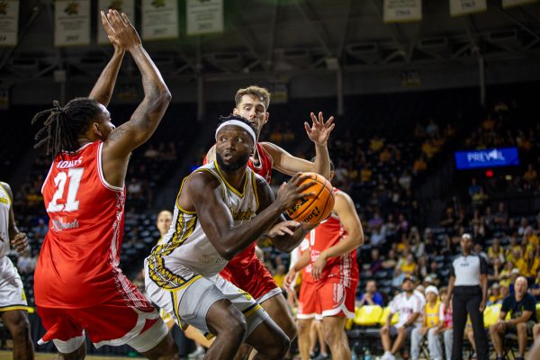Aftershocks Forward Morris Udeze looks for an open pass under the basket against The Enchantment on July 23. Udeze had the option to play for either the Aftershocks or The Enchantment.