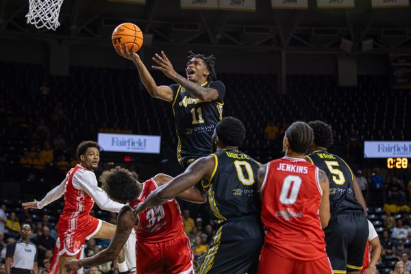 AfterShocks Guard Chaunce Jenkins rises above the defense for an open layup against The Enchantment on July 24. The AfterShocks won, 73-67 to seal the series and send them to round two against JHX Hoops.